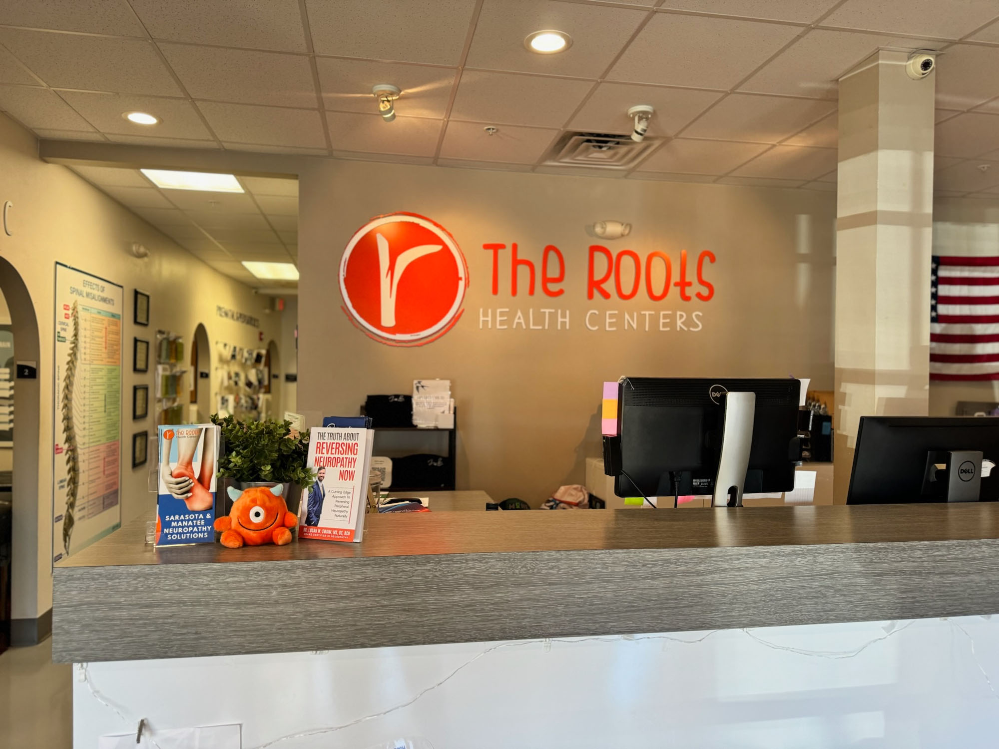 The Roots reception desk with Dr. Logan's neuropathy book on display.